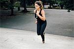 Woman running up steps in park