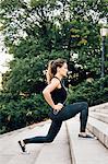 Woman stretching on steps in park