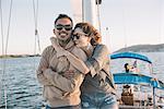 Couple enjoying view on sailboat, San Diego Bay, California, USA