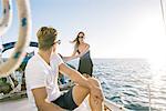Couple chatting on sailboat, San Diego Bay, California, USA