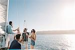 Friends chatting on sailboat, San Diego Bay, California, USA