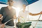 Man steering wheel of sailboat, San Diego Bay, California, USA