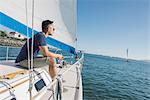 Man enjoying view on sailboat, San Diego Bay, California, USA