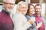 Portrait smiling couples drinking coffee outdoors