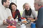 Couples talking and enjoying breakfast at patio table