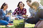 Family barbecuing at campsite grill