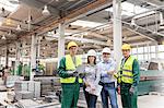 Portrait confident engineers and workers in steel factory