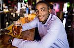 Smiling businessman having a drink