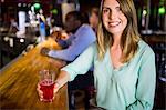 Smiling businesswoman having a drink