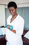 Woman looking at dumbbells while exercising