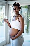 Portrait of smiling woman holding glass of water