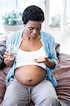 Pregnant woman about to take her pills