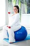 Pregnant woman exercising with ball