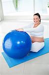 Pregnant woman exercising on ball