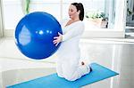 Pregnant woman exercising on ball