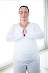 Pregnant zen woman doing yoga