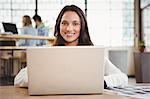 Portrait of smiling businesswoman with laptop