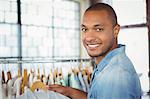 Portrait of smiling man holding shirt at mall