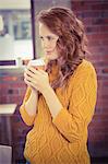 Woman holding coffee at office