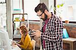 Man holding camera at office