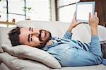 Portrait of happy man holding digital tablet