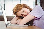 Businesswoman sleeping on laptop