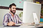 Happy businessman working on computer