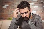 Close-up of stressed man with hand on head