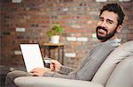 Portrait of happy man shopping online at home
