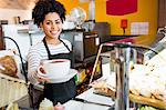 Waitress serving cappuccino to camera