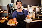 Handsome waiter smiling at camera