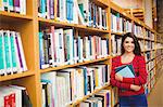 Portrait of happy female student with books