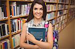 Confident young student holding book