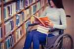 Mid section of disabled female student reading book