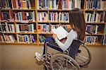 Disabled student reading book on wheelchair