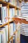 Woman with book in library