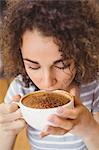 Pretty student having a coffee