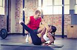 Muscular couple doing a leg stretching