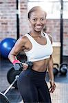 Muscular smiling woman posing to the camera