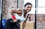 Muscular smiling woman posing to the camera