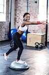 Muscular smiling woman doing some stretching