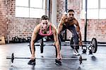 Fit couple lifting weight together