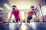 Fit couple doing push ups