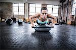 Woman doing bossu ball exercises