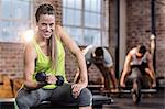 Fit woman doing dumbbell exercise