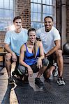 Smiling woman crouching with trainers