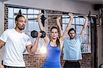 Three muscular athletes lifting weights