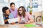 Businessman explaining colleagues over document