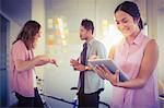 Creative businesswoman smiling and using digital tablet