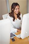 Businesswoman smiling while working on computer